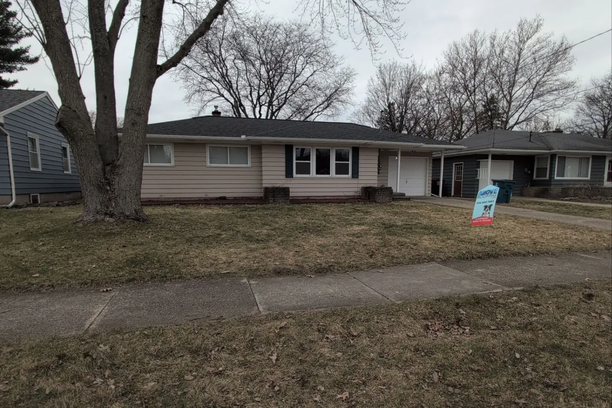 Above Roofing yard sign in front of a Kentwood, MI ranch home with a newly replaced architectural shingle roof