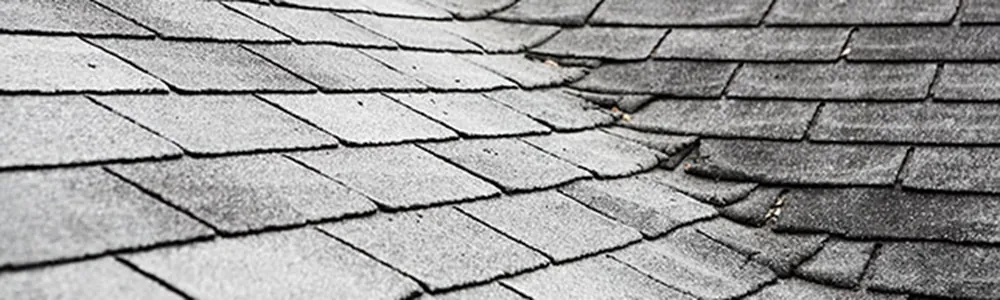 Old roof with damaged shingles