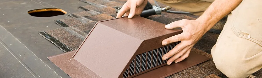 Installing an attic vent on the roof of a house
