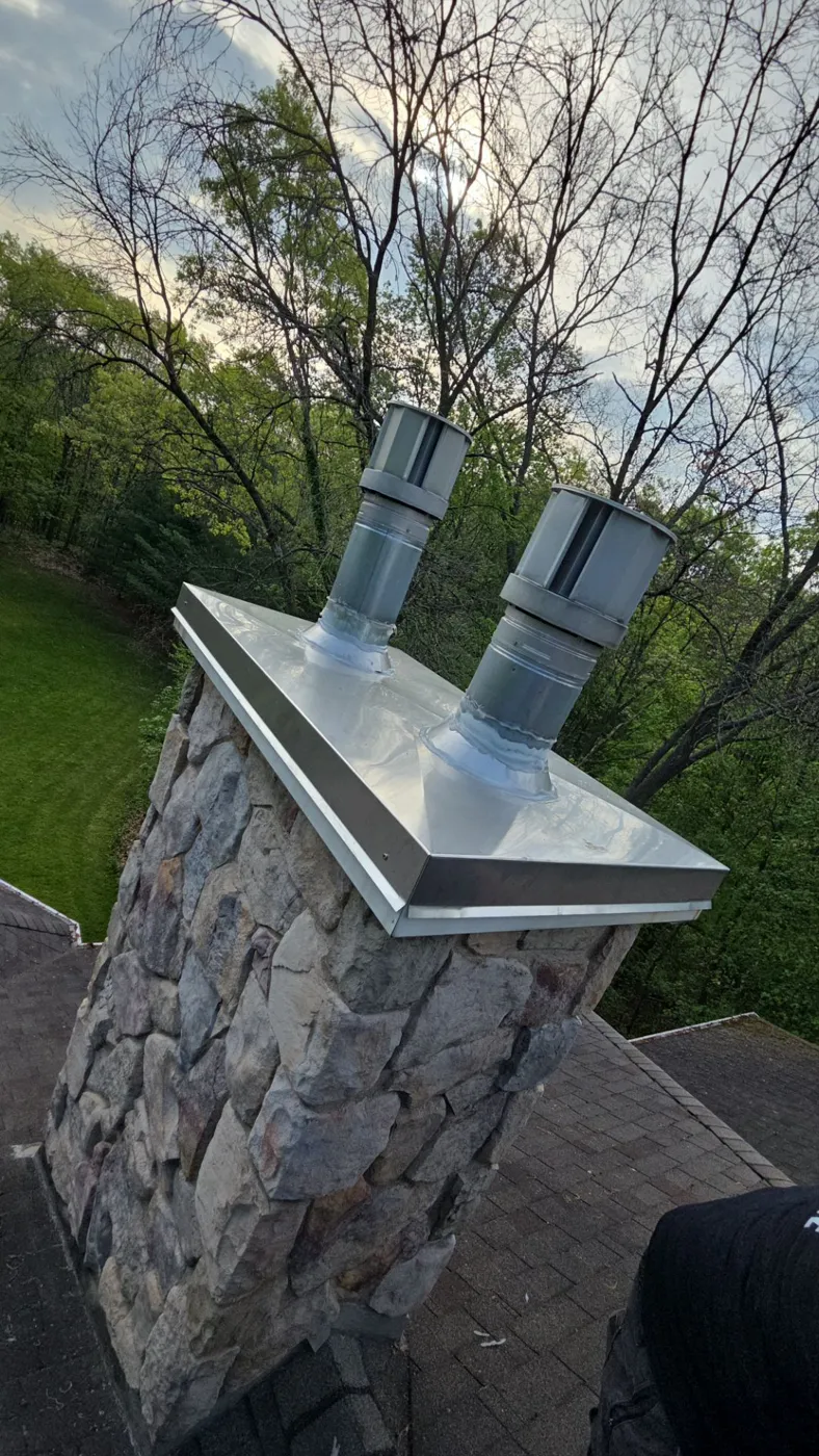 New stainless steel chimney chase cap installed by Above Roofing