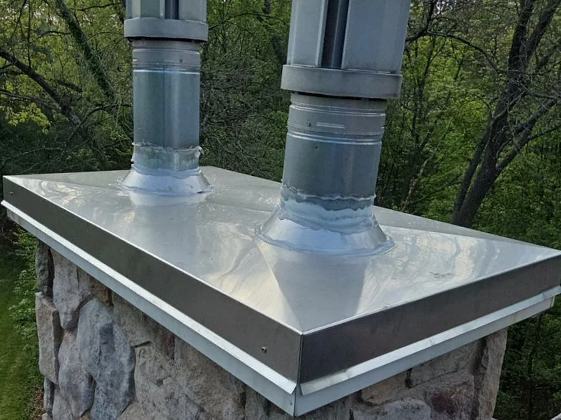 New stainless steel chimney chase cap installed by Above Roofing