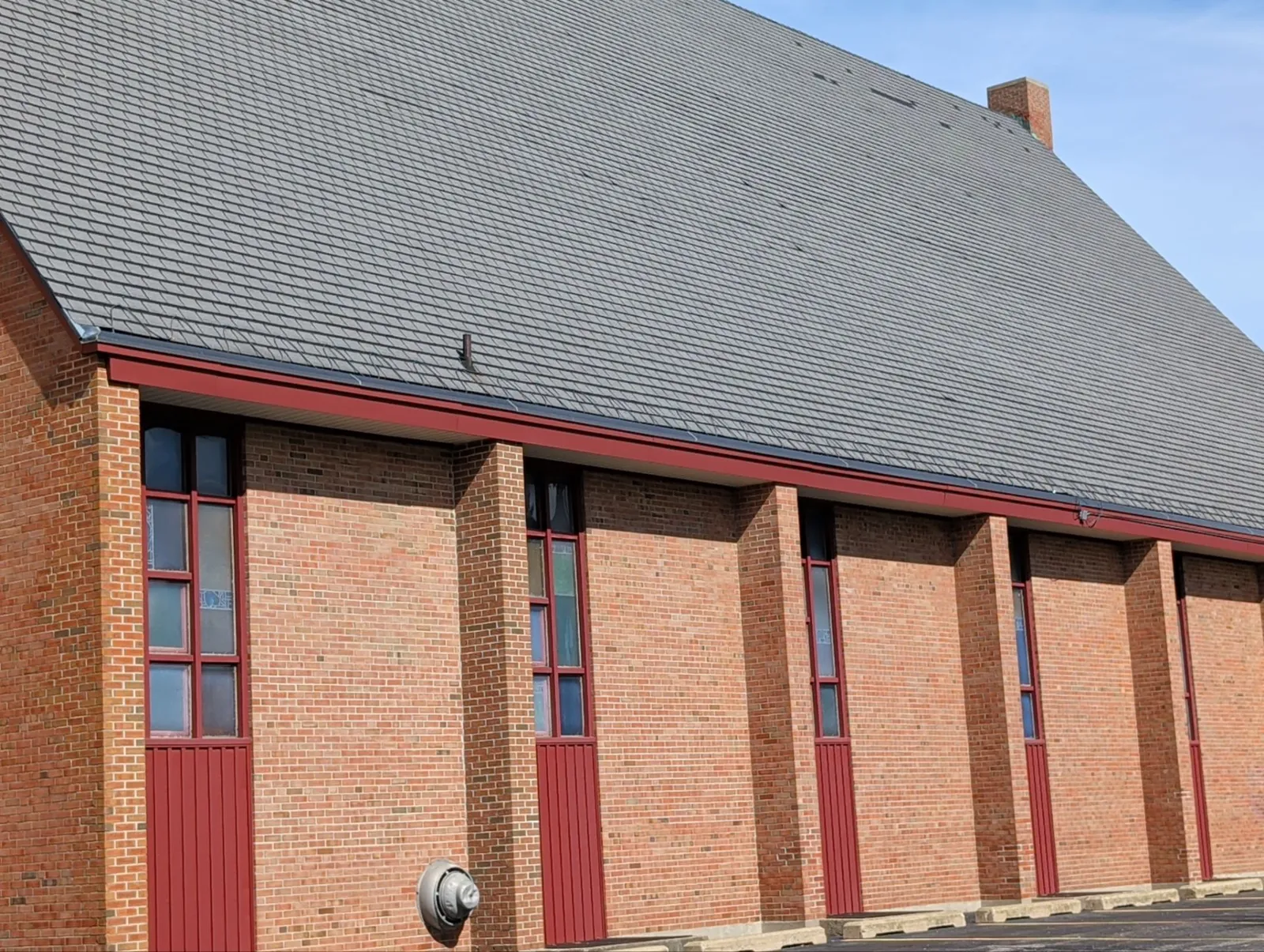 Worn, faded original shingles on the pitched sanctuary roof of Calvin Christian Reformed Church in Grand Rapids, MI before replacement