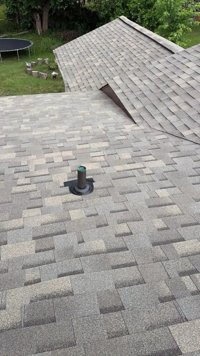 Finished shingle roof valley and vent on a newly replaced roof in Kentwood, MI